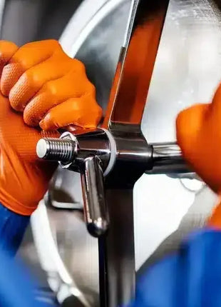 Hände mit orangefarbenen Schutzhandschuhen bedienen Edelstahlgerät, Hygiene Arbeitsplatz