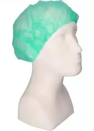 Grüne Einweghaube aus Vlies auf Modellkopf, Hygieneschutz für Medizin und Pflege
