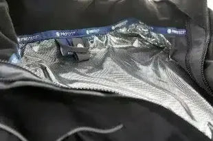 Detailaufnahme einer schwarzen Schutzjacke mit reflektierendem Innenfutter, Hygieneprodukt